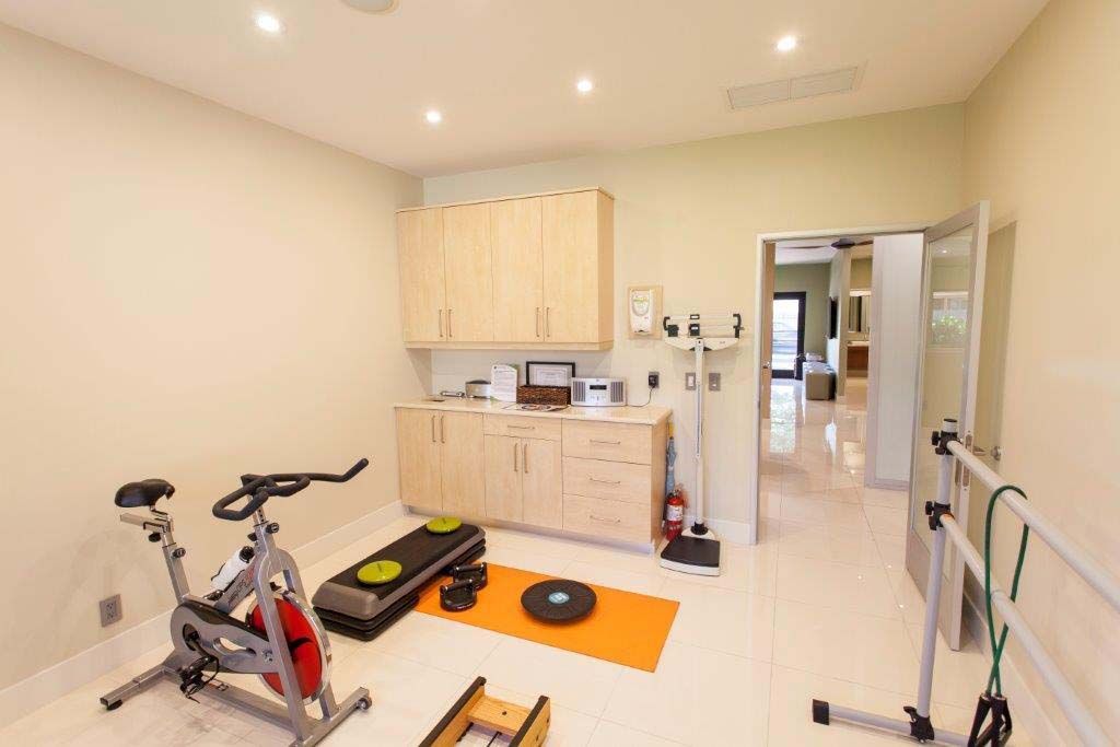 There is a spinning bike in the middle of the room.