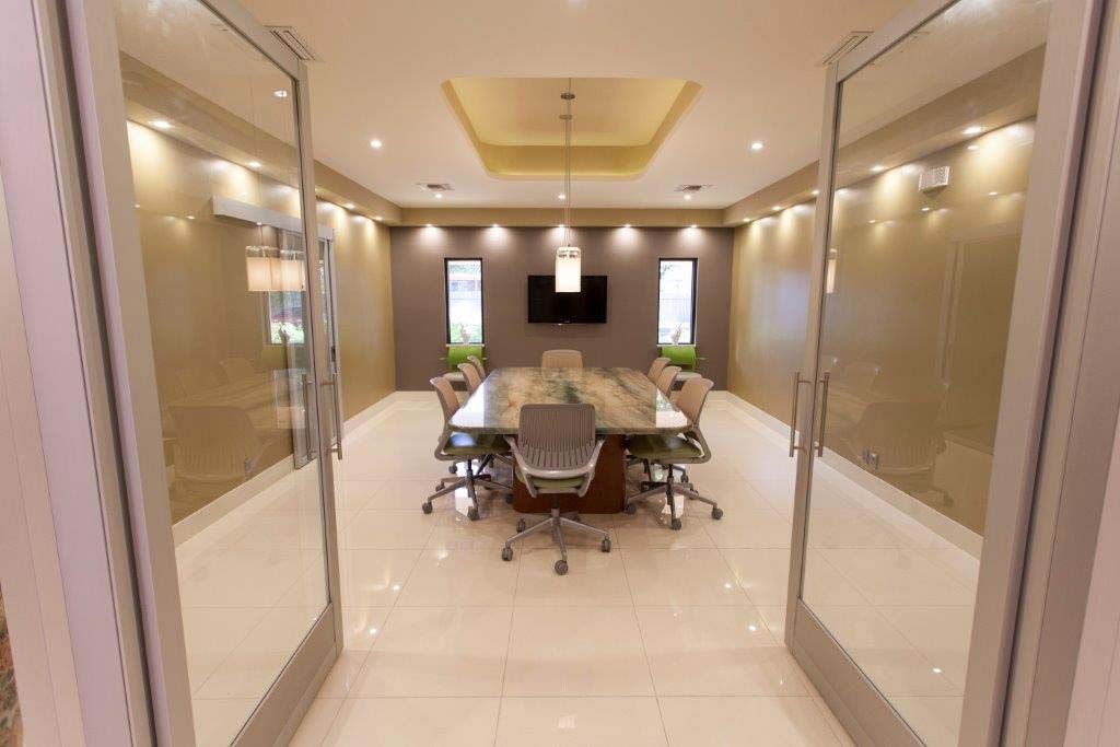 A conference room with a long table and chairs.