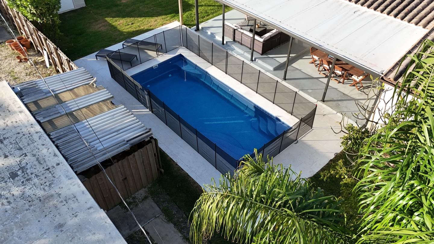 An aerial view of a large swimming pool in a backyard