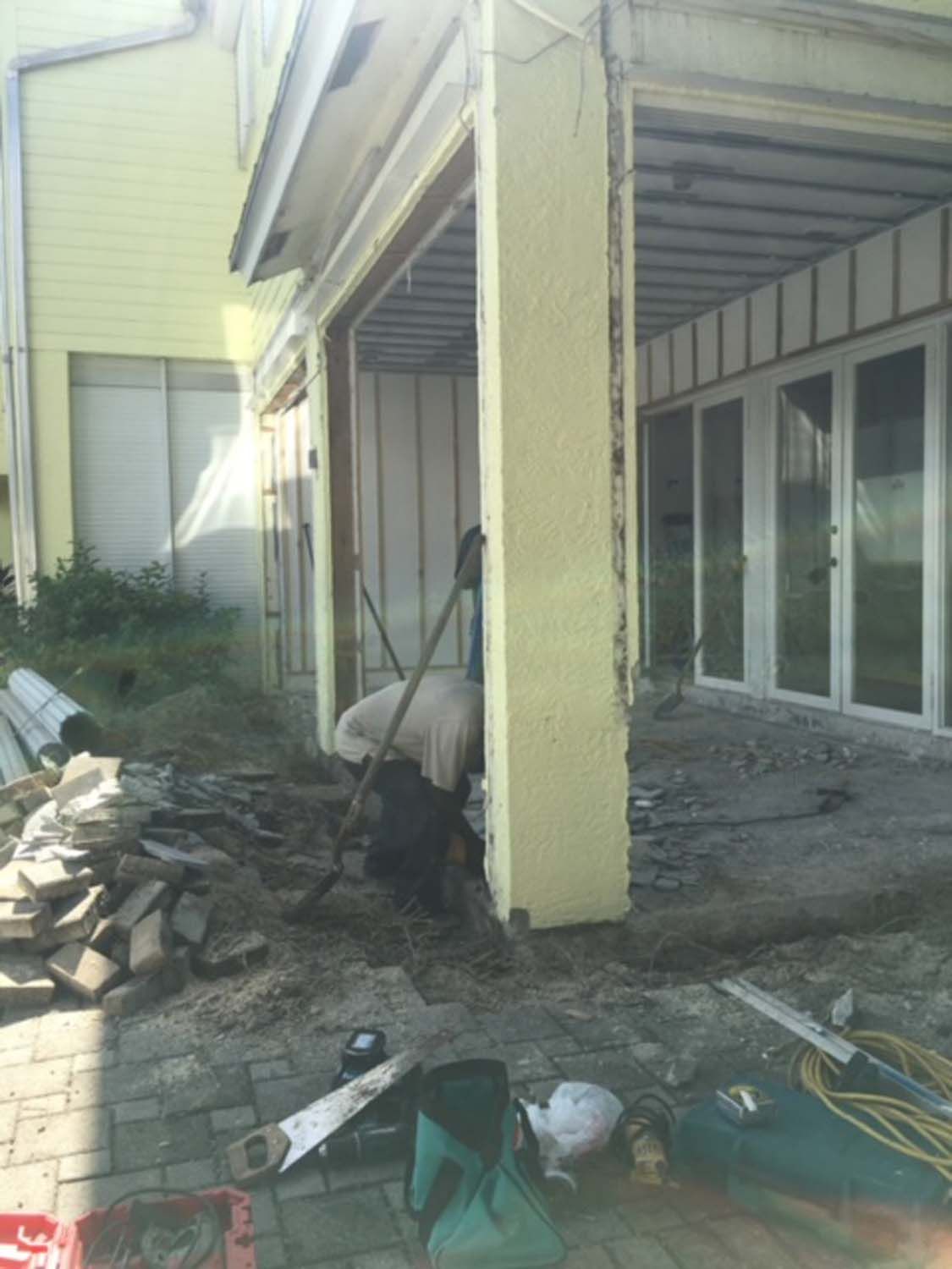 A man is working on the side of a building.