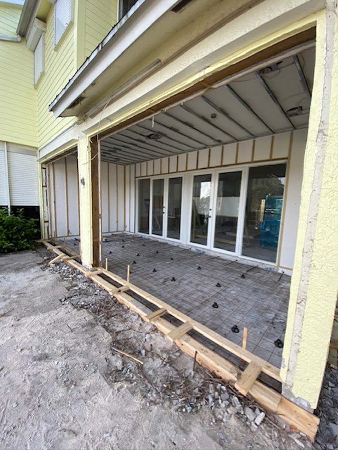 A building under construction with a sliding glass door.