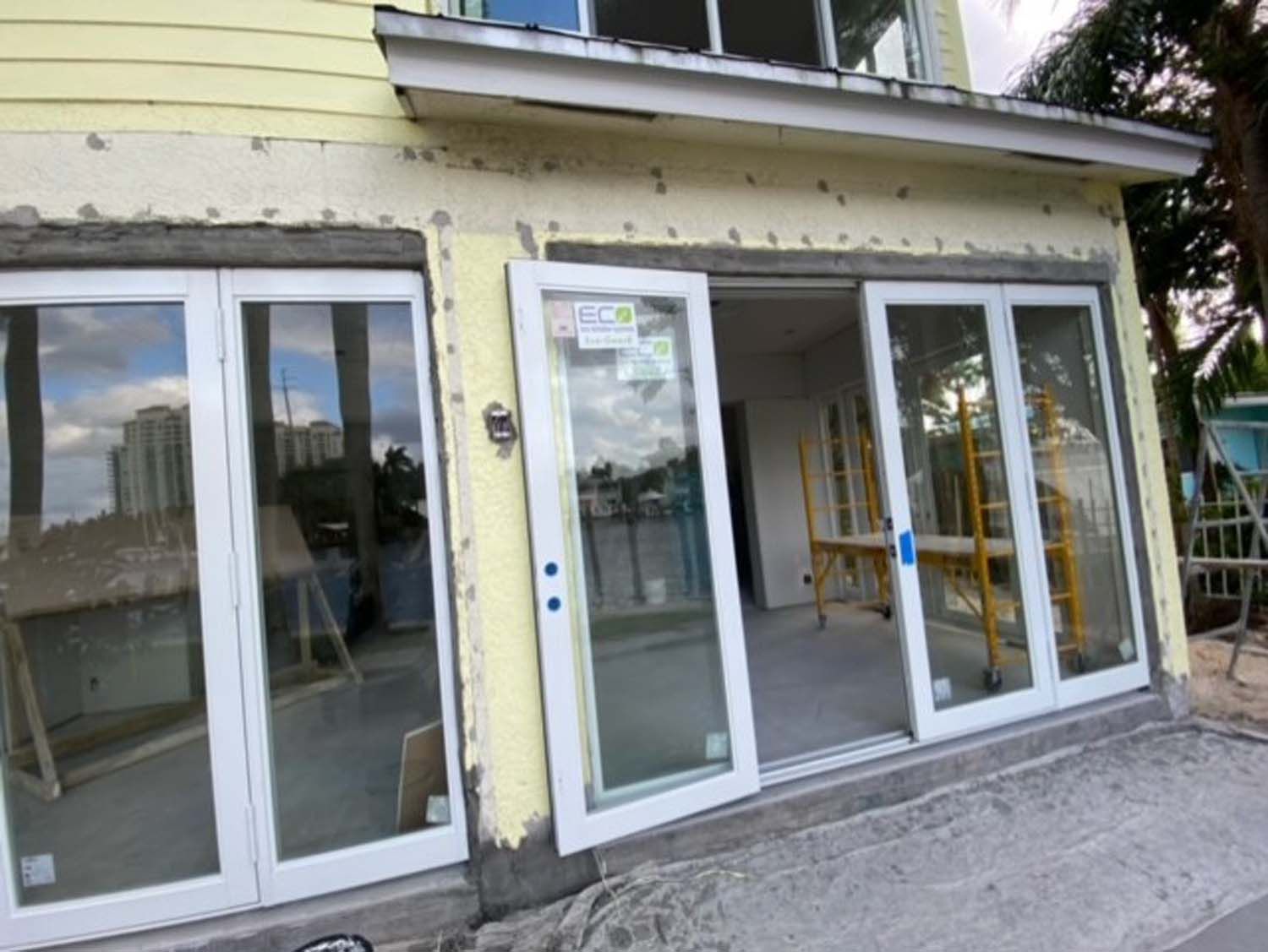 A building under construction with a lot of windows and doors.