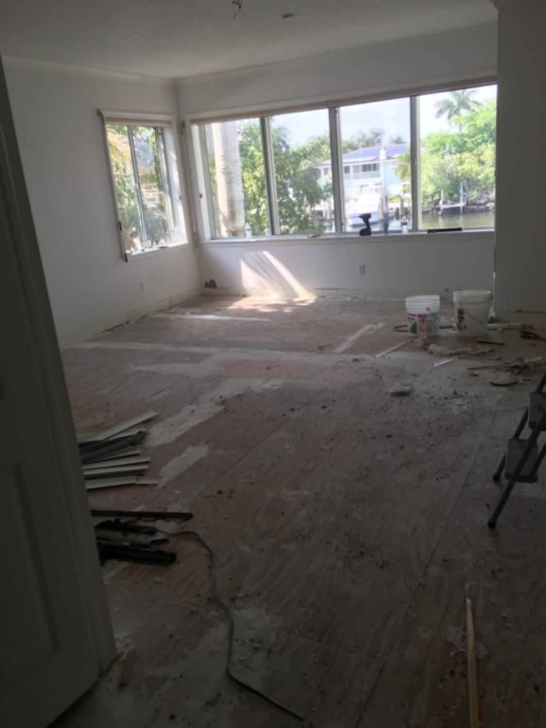 An empty room with a lot of windows and a ladder