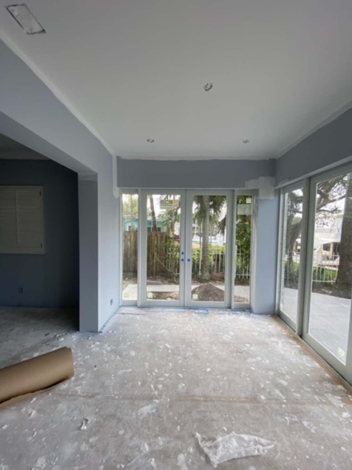 An empty room with a lot of windows and doors