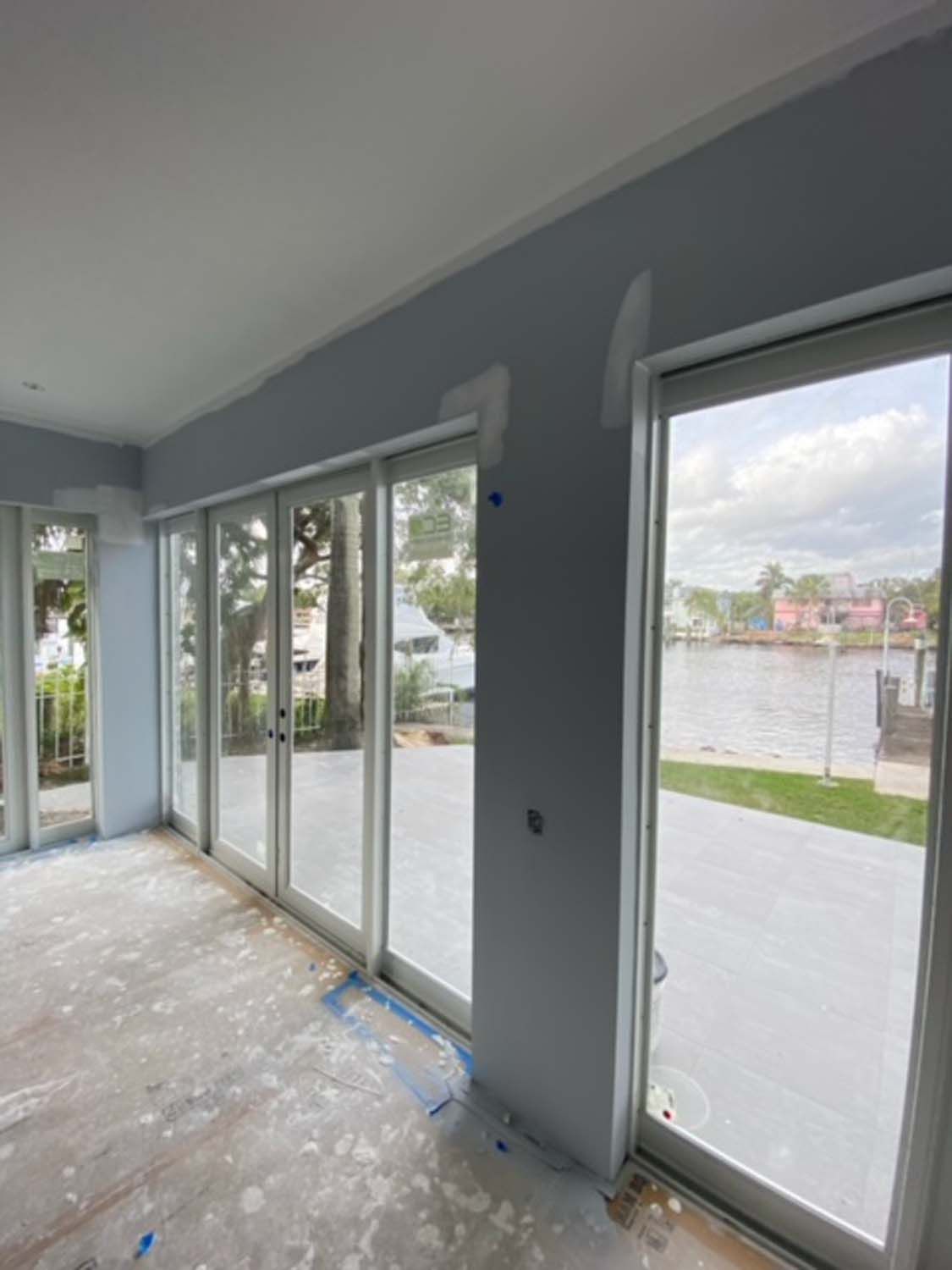 A room with a lot of windows and a view of the water.