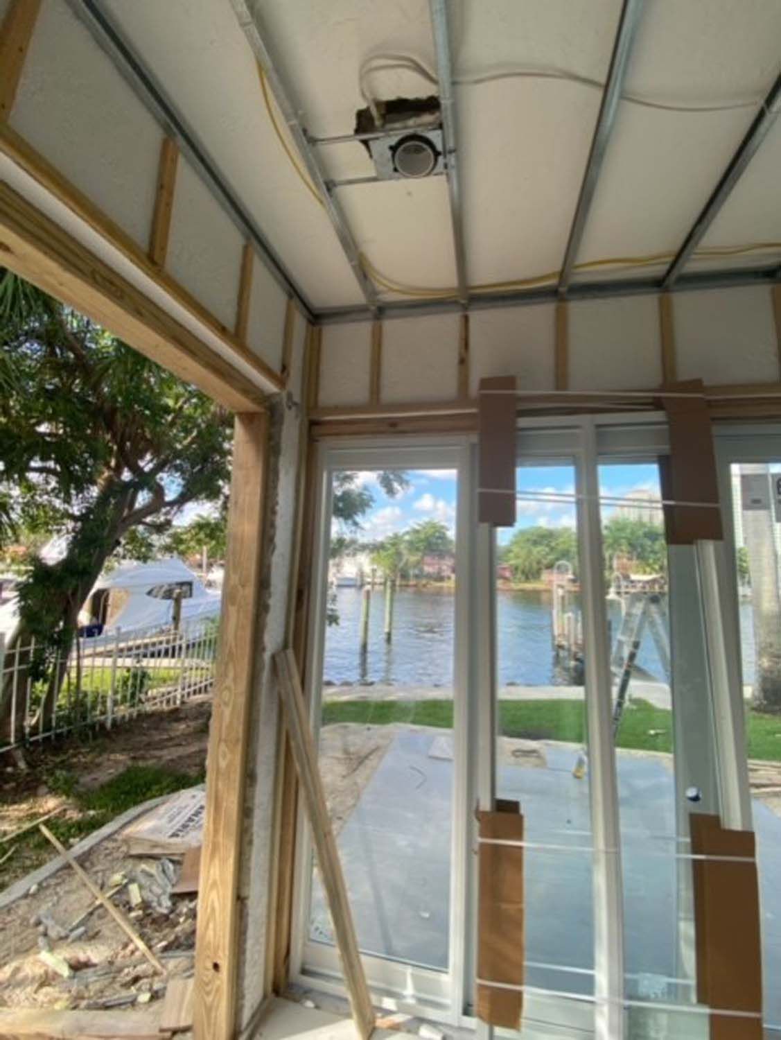 A room with a lot of windows and a ceiling fan