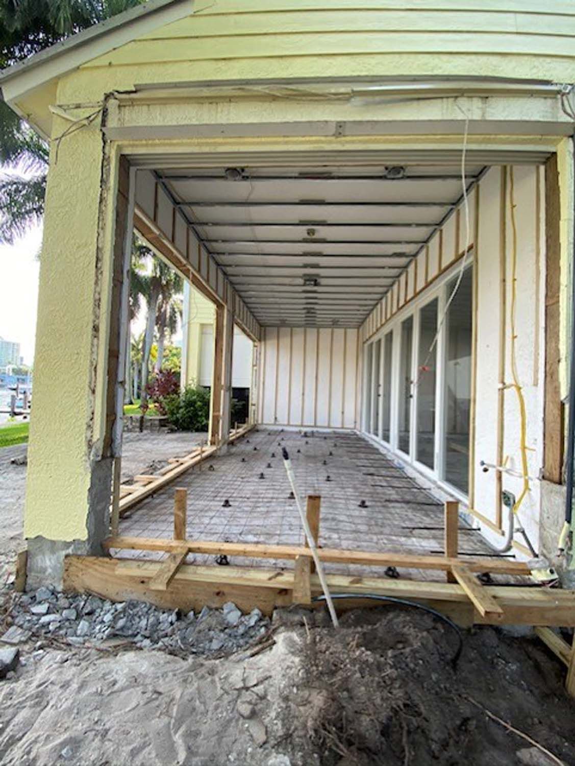 A house is being remodeled and the garage door is open.