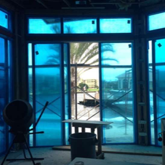 A room with a lot of blue windows and a concrete mixer