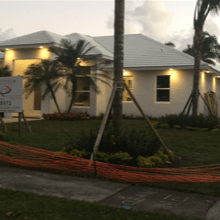 A white house with a sign in front of it that says 