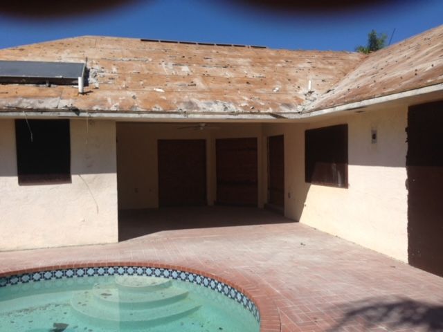 A house with a swimming pool in front of it