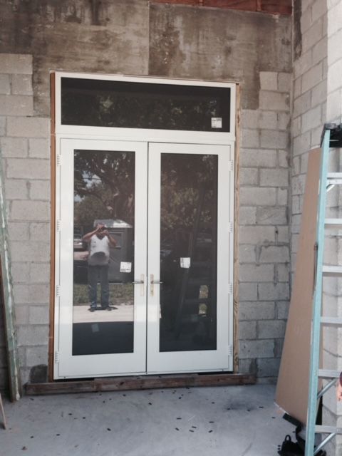 A white door with a reflection of a person in it