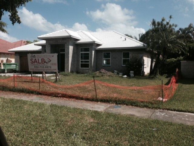 A house with a for sale sign in front of it