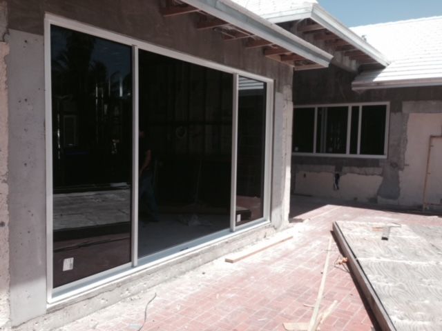 A house under construction with a large sliding glass door