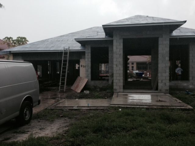 A van is parked in front of a house under construction