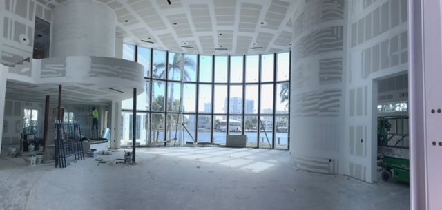 A large room with a lot of windows is being built.