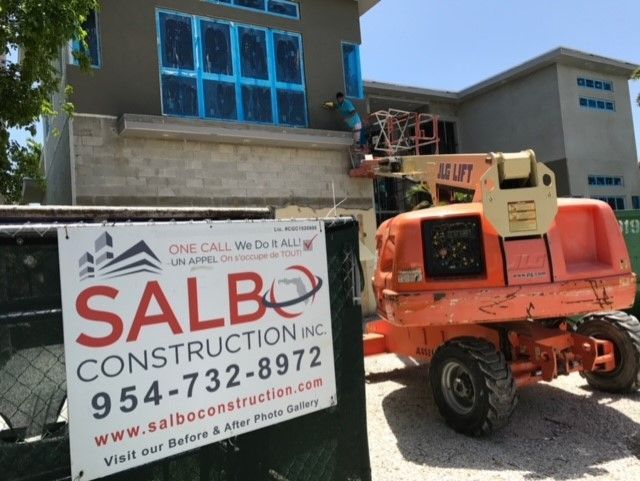 A sign for salbo construction inc sits in front of a building