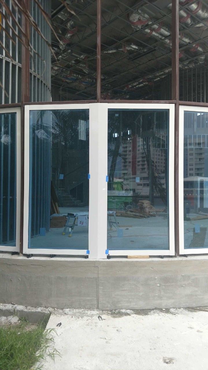 A building under construction with a lot of windows and doors.