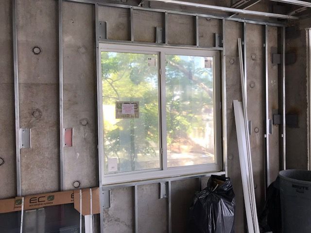 A building under construction with a window in the middle of it