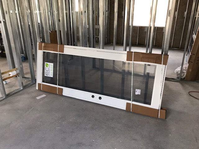 A door is sitting on the floor in a room under construction.