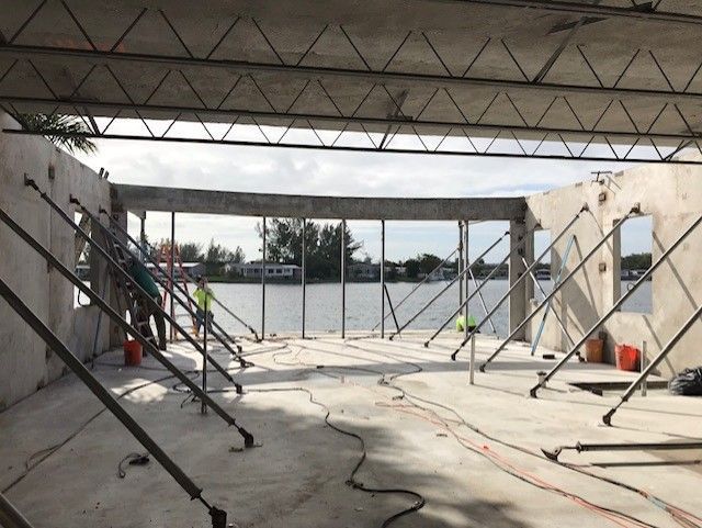 A building under construction with a view of a body of water.