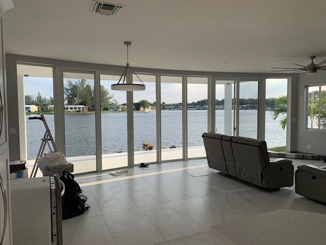 A living room with a couch and a view of a lake.