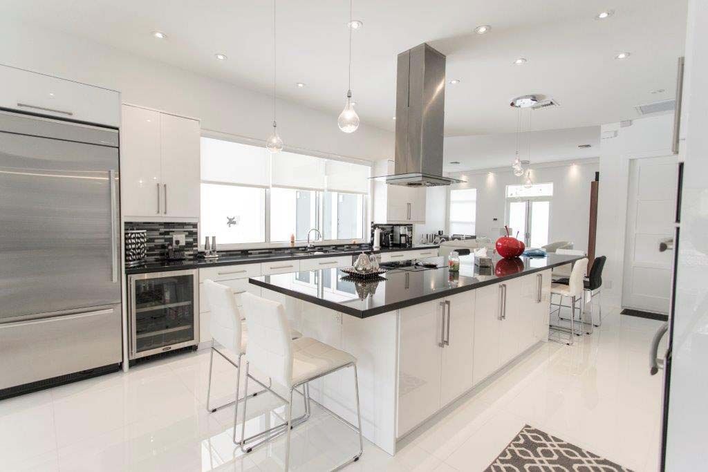 A large kitchen with white cabinets and stainless steel appliances.