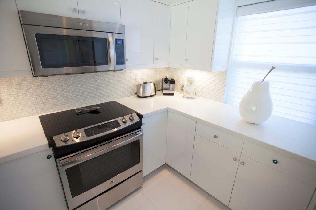 A kitchen with stainless steel appliances and white cabinets