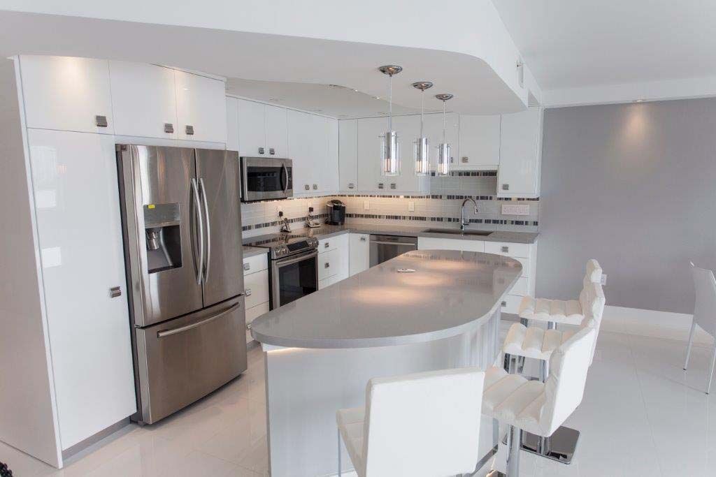 A kitchen with stainless steel appliances and white cabinets