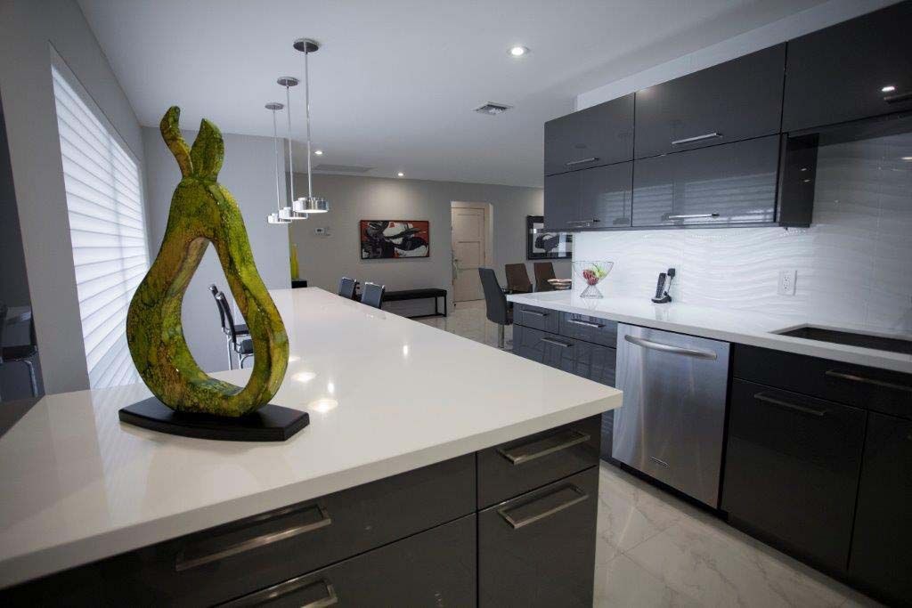 A kitchen with a statue of a pear on the counter.