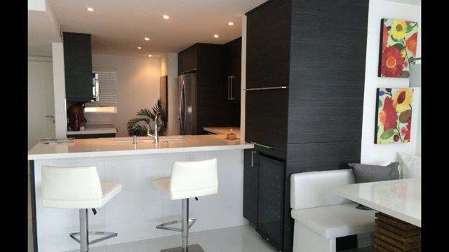 A kitchen with a table and chairs and a refrigerator