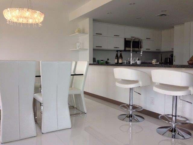 A kitchen with a table and chairs and a bar
