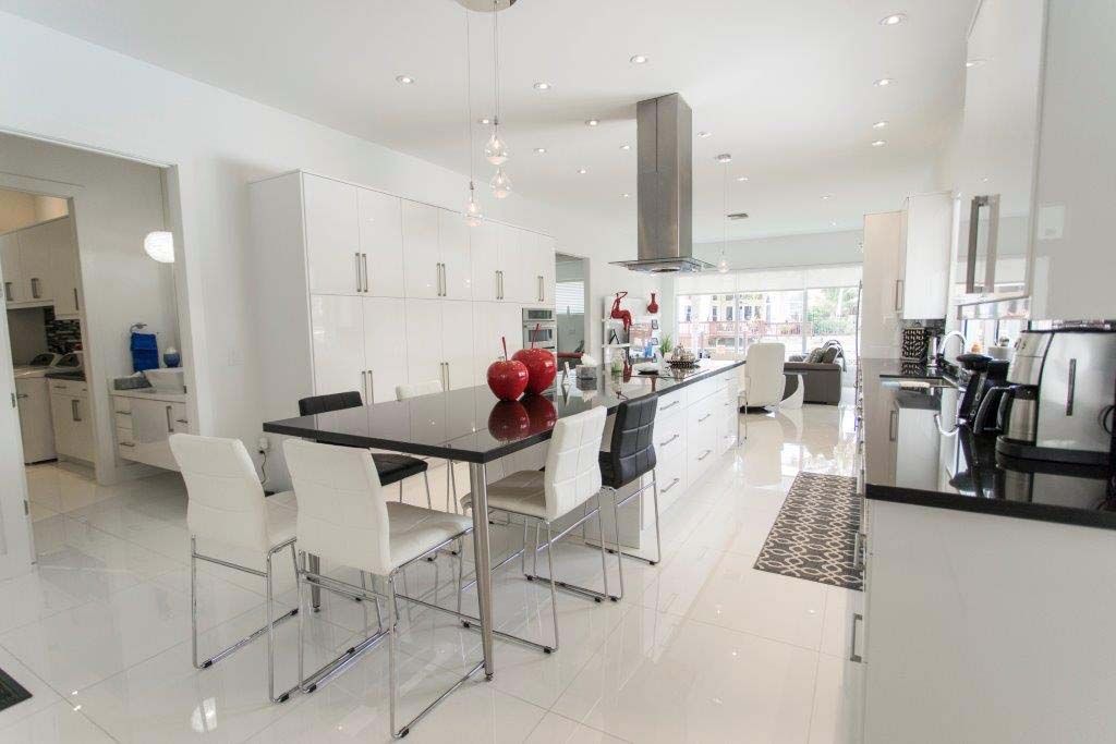 A kitchen with a dining table and chairs in it.