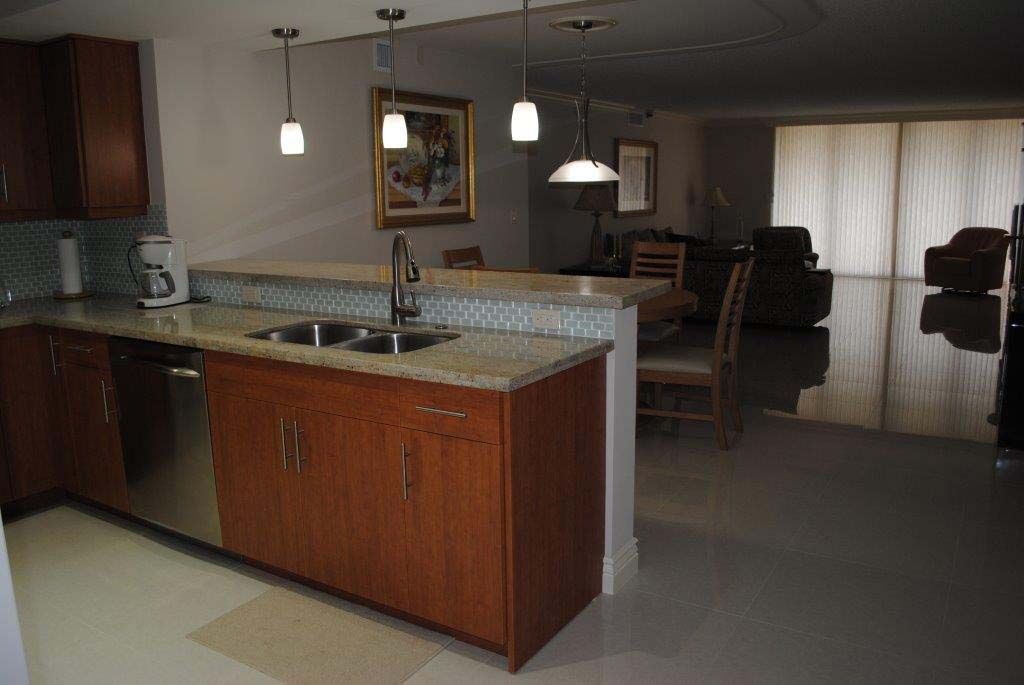 A kitchen with a sink , dishwasher , and stainless steel appliances.