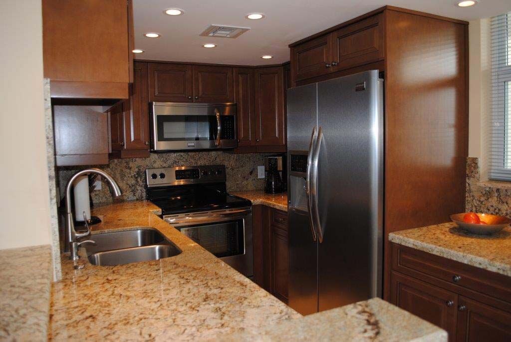 A kitchen with stainless steel appliances and granite counter tops