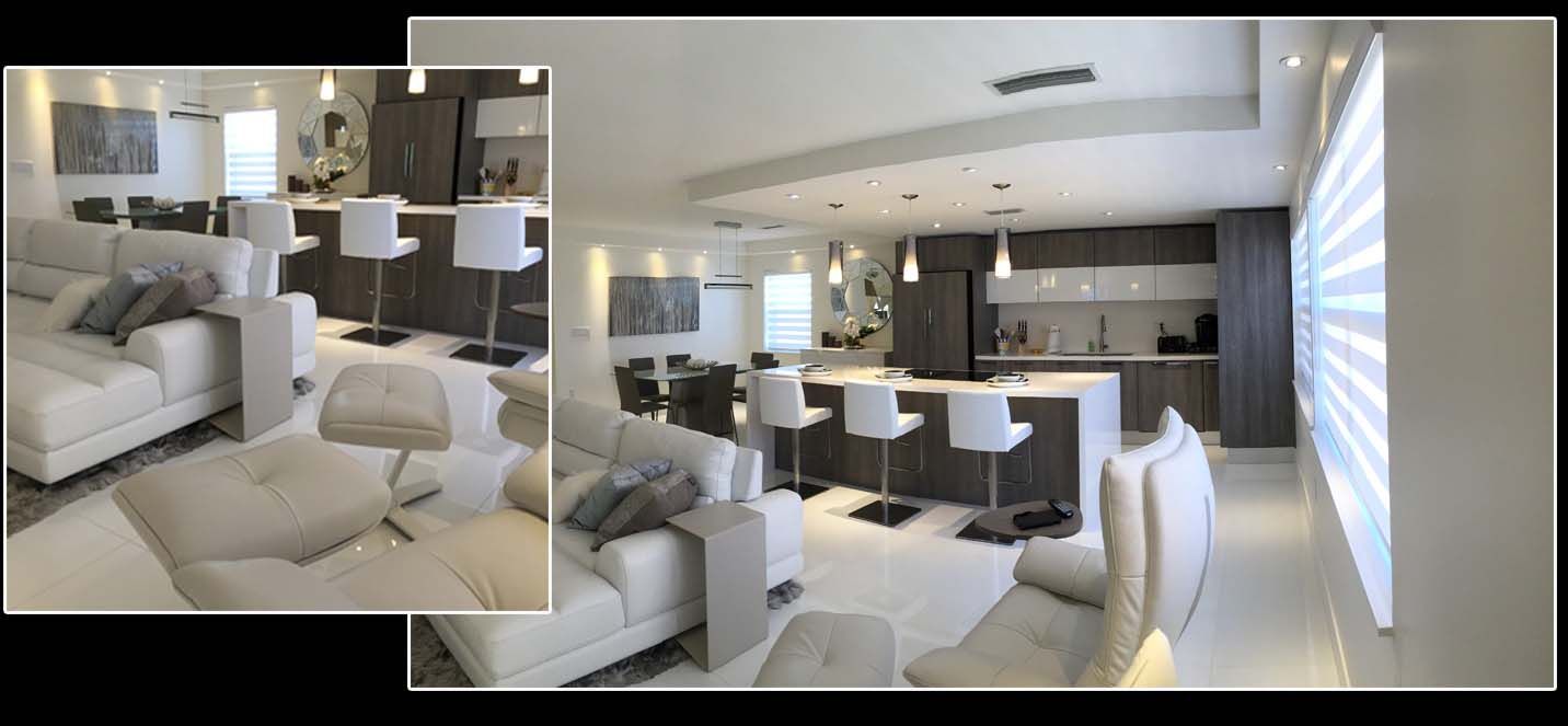 A living room with a couch and a kitchen in the background