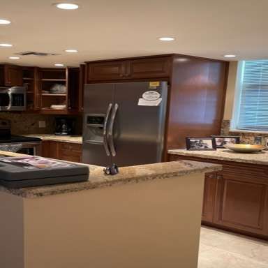 A kitchen with a stainless steel refrigerator and a microwave.