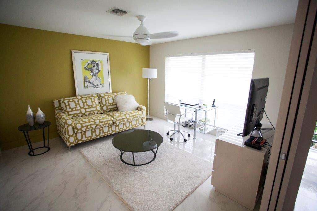 A living room with a couch , coffee table , and television