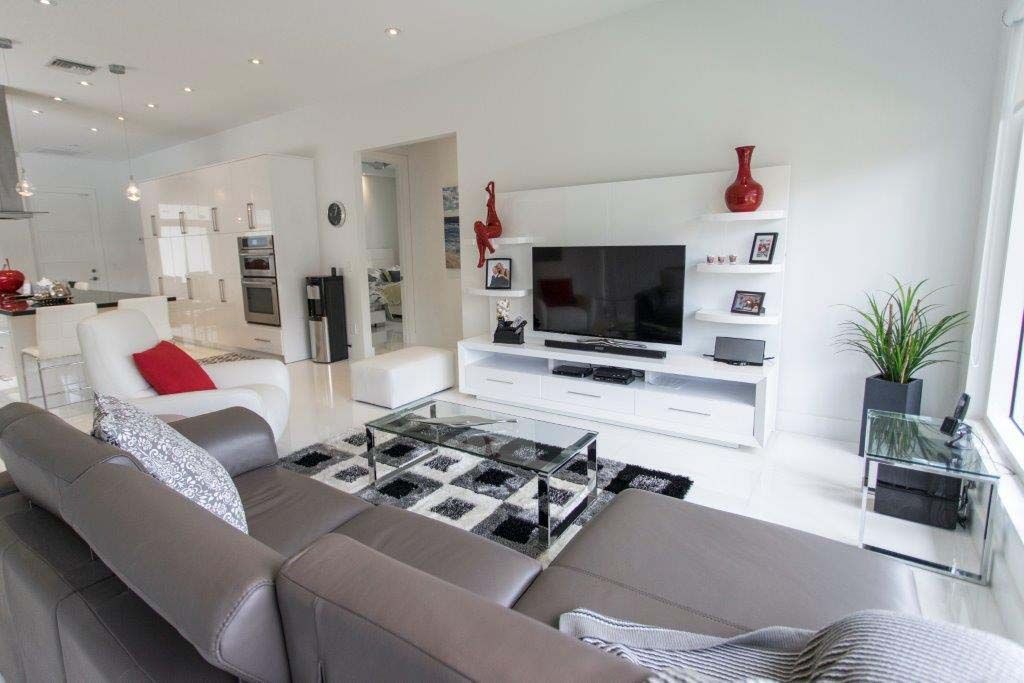 A living room with a couch , table , and television.