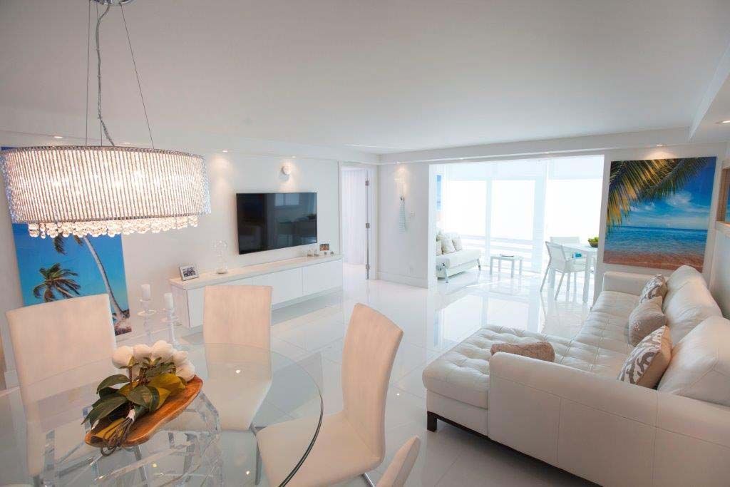 A living room with a couch , table , chairs and a television.