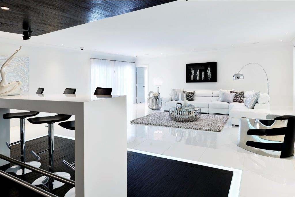 A black and white living room with a table and chairs