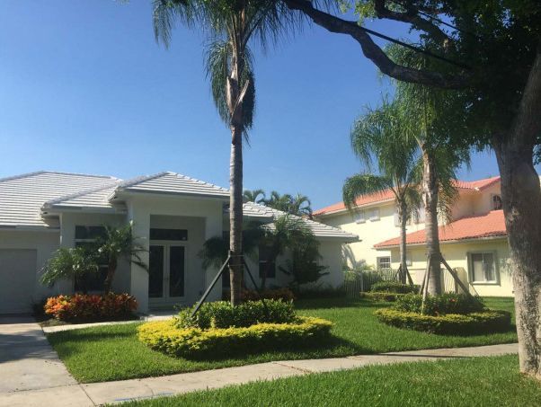 A white house with palm trees in front of it