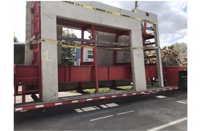 A large concrete structure on a trailer with the number 1 on it