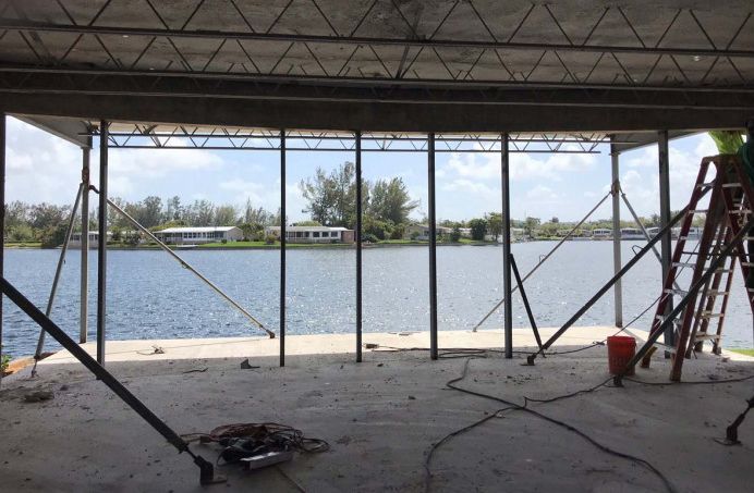 A building under construction with a view of a lake