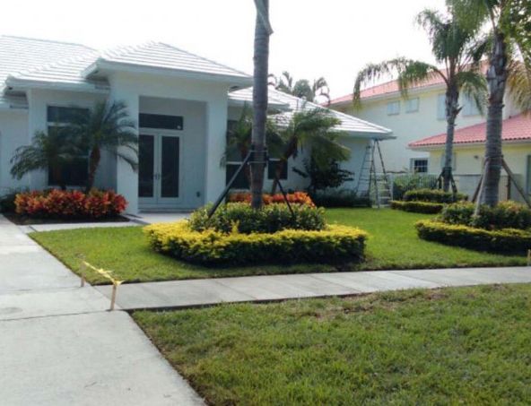 A white house with palm trees in front of it