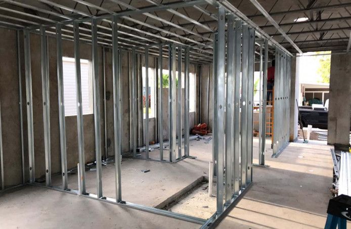 A room with a lot of metal frames on the wall.