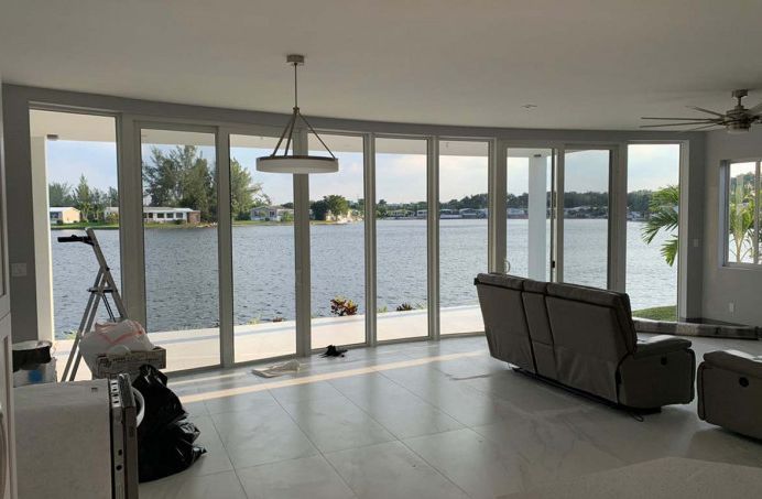 A living room with a couch and a view of a lake.