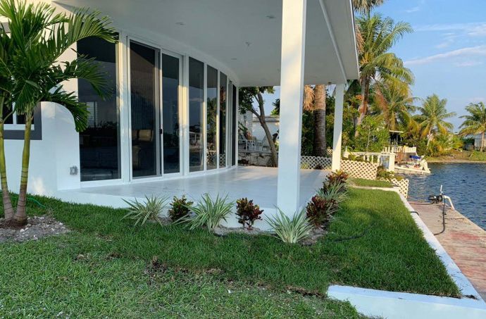 A house with a lot of windows and a lawn in front of it