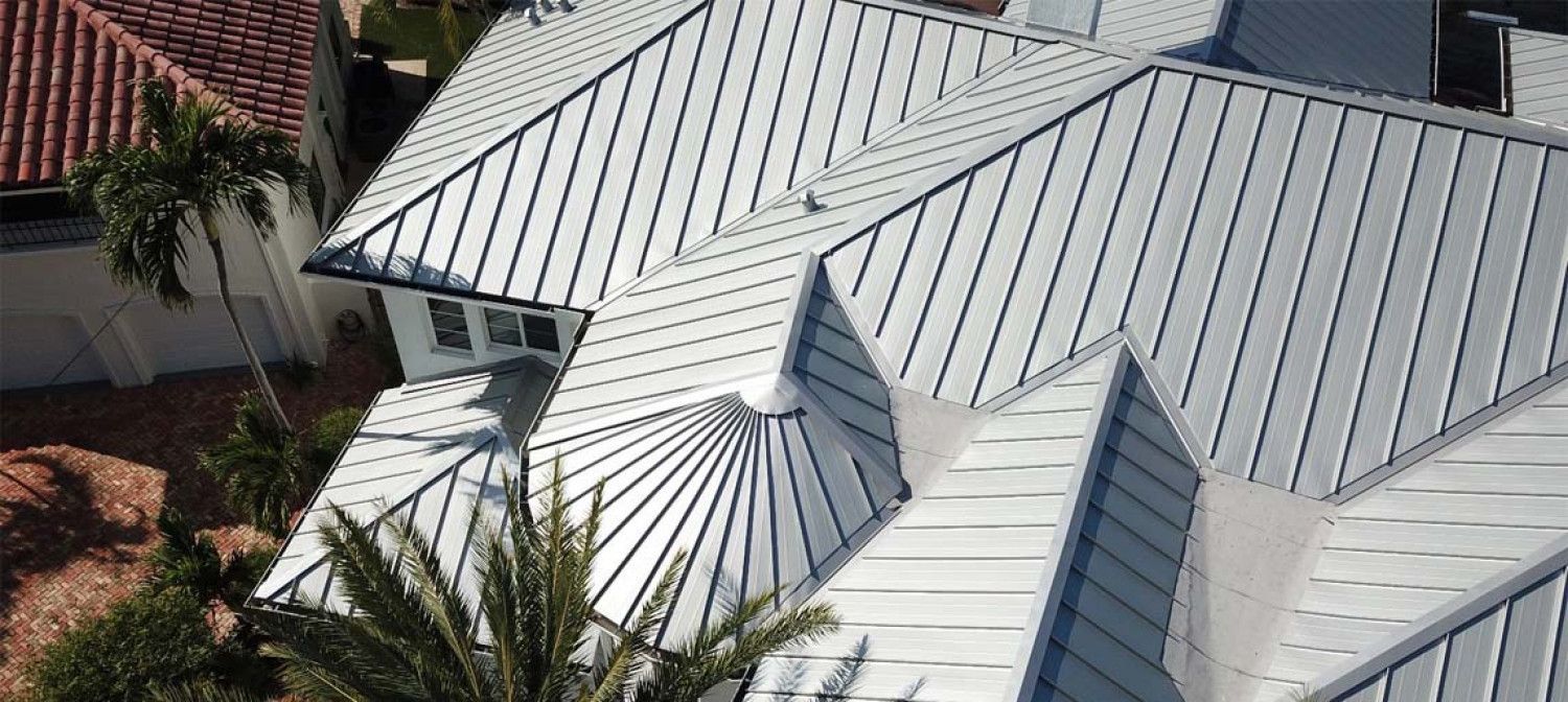 An aerial view of a house with a metal roof.