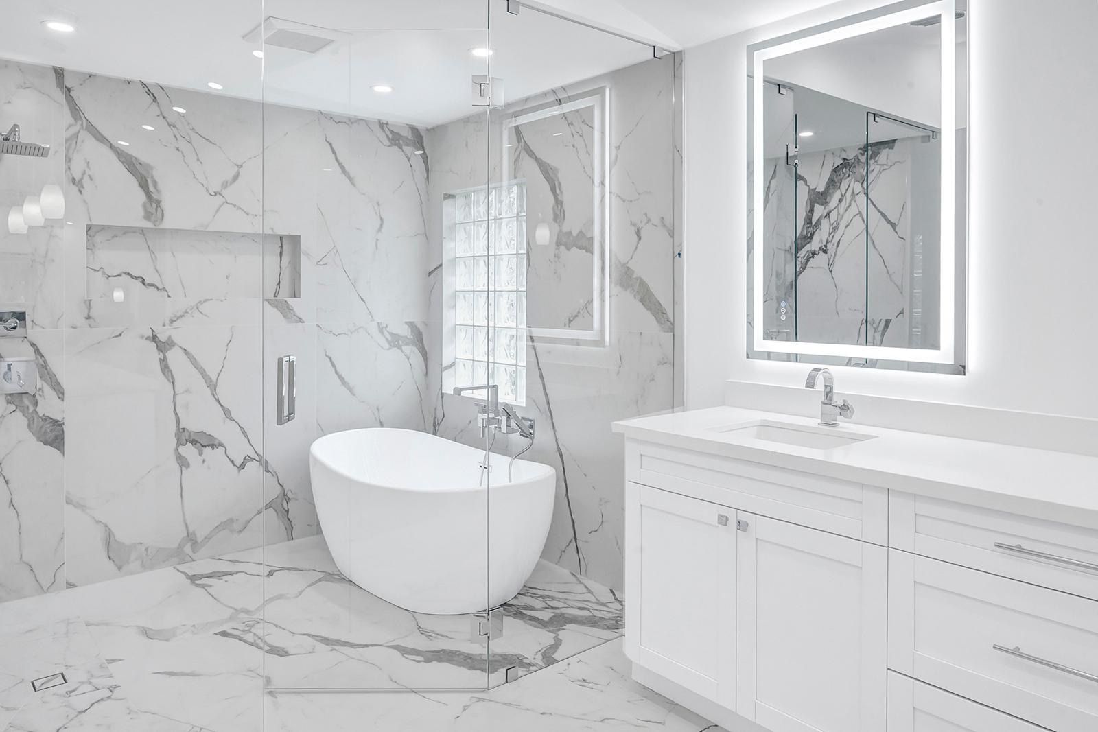 A bathroom with a bathtub , sink , and mirror.