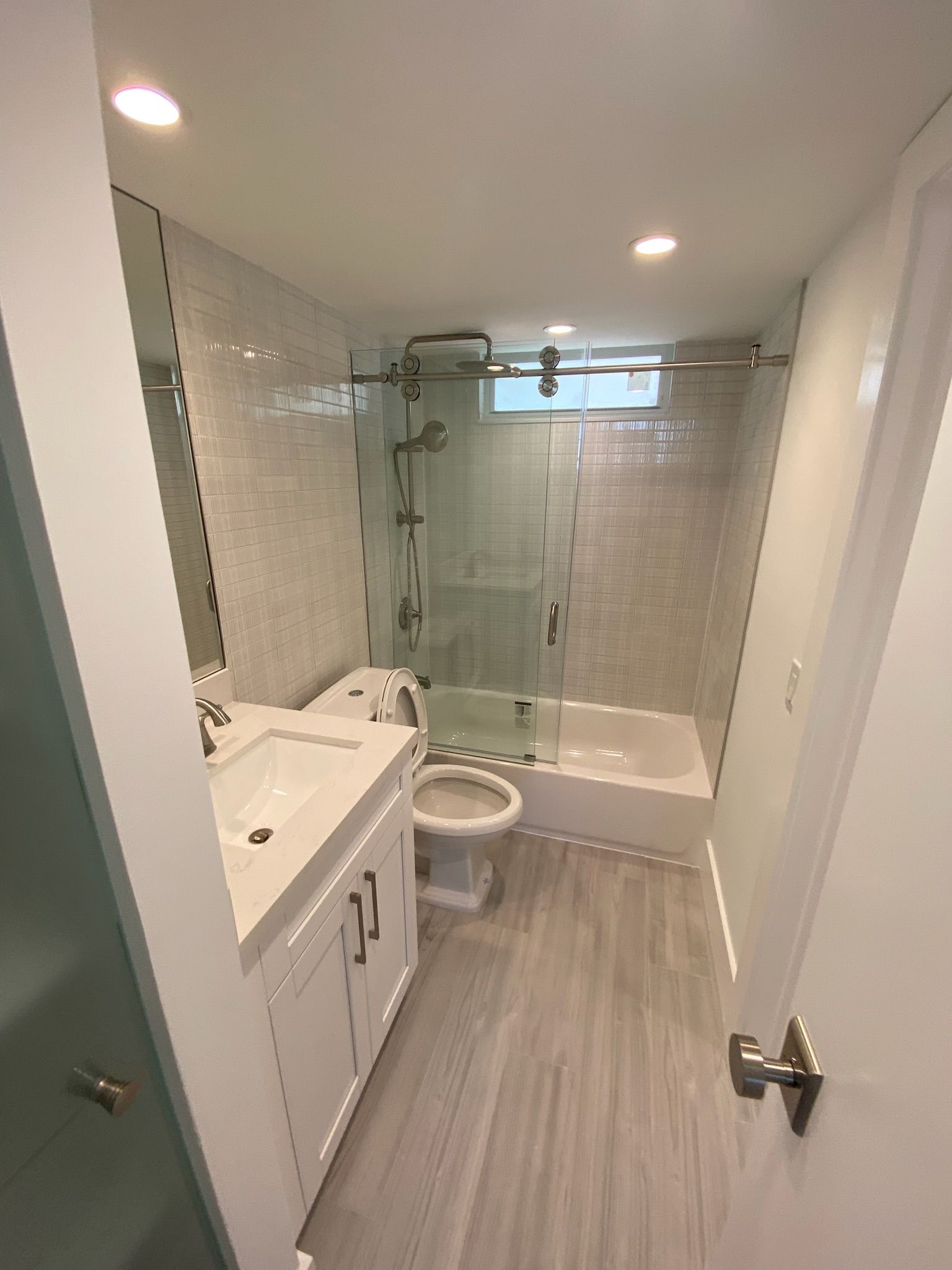 A bathroom with a toilet , sink , shower and bathtub.